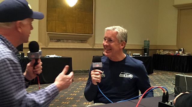Boomer Esiason talks with Seahawks head coach Pete Carroll at Super Bowl XLIX (Aaron Cummins/Westwood One)