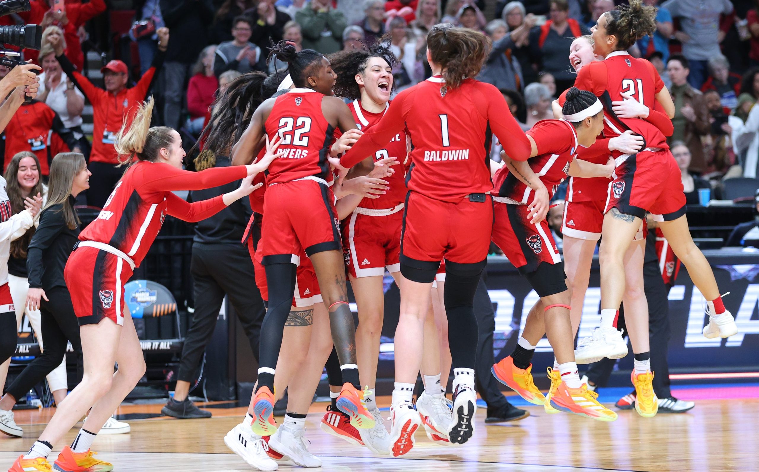 PORTLAND, OREGON - MARCH 31: The NC State Wolfpack celebrate their 76-66 win over the Texas Longhorns during the Elite Eight round of the 2024 NCAA Women's Basketball Tournament held at the Moda Center on March 31, 2024 in Portland, Oregon. (Photo by Alysa Rubin/NCAA Photos via Getty Images)